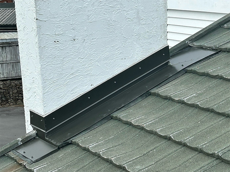 Chimney flashing repair in tile roof